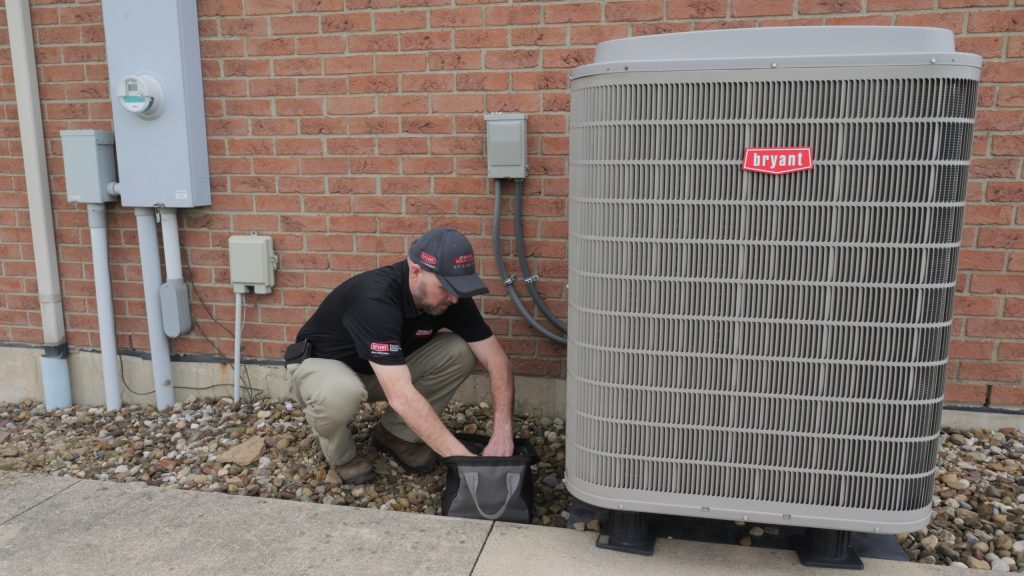 HVAC technician working on a Bryant HVAC system, representing Dave’s Services, a trusted HVAC company providing expert heating, furnace, heater, AC, air conditioning, air conditioner, cooling, heat pump, and indoor air quality services, including repair, maintenance, and installation for homes in Troy, Tipp City, Piqua, Vandalia, West Milton, and Pleasant Hill. Contact us now for help with HVAC company, local HVAC company near me, heating repair, heater service, furnace repair, furnace maintenance, AC repair, air conditioner repair, air conditioning service, air conditioning maintenance, cooling system repair, heat pump repair, heat pump maintenance, HVAC maintenance, HVAC installation, HVAC repair near me, emergency HVAC service, residential HVAC services, commercial HVAC services, indoor air quality solutions, Bryant HVAC dealer, professional HVAC technicians, reliable heating and cooling service, energy-efficient HVAC installation, ductless HVAC service, seasonal HVAC tune-up, trusted HVAC contractors, local heating and cooling experts, AC service near me, furnace service near me, heat pump service near me, HVAC inspection near me.